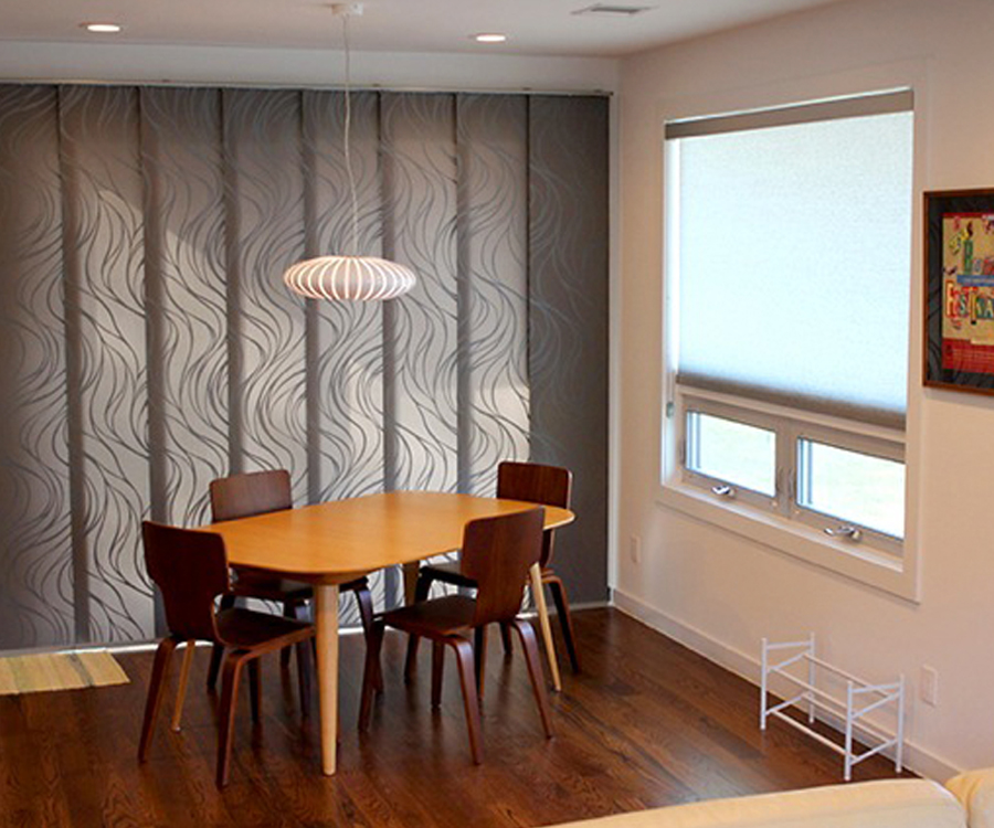 gliding panel track blinds cover large doors in Austin TX kitchen