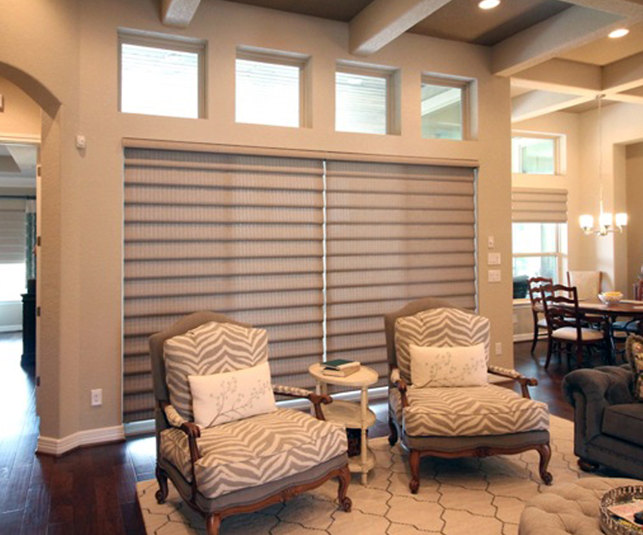 textured fabric roman shades cover large windows and doors