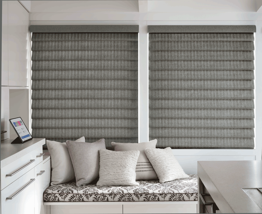 gray fabric roman shades by window seat