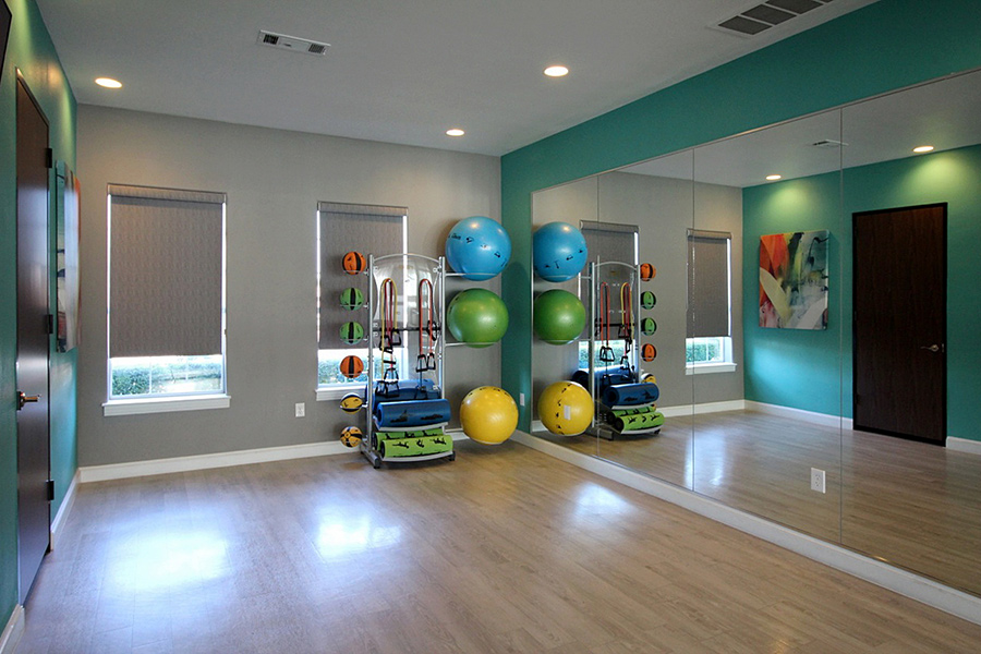 yoga studio with roller shades window coverings for commercial spaces in Austin 78758