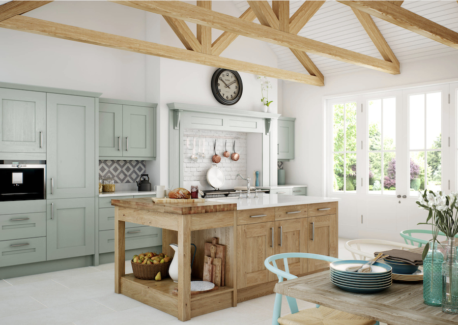 Kitchen with green cabinets and warm wood tones.