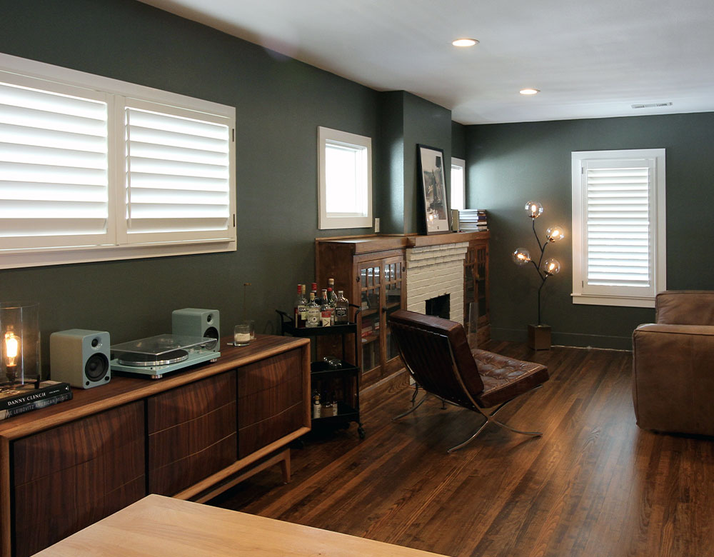 white shutters with green walls in Austin TX living room