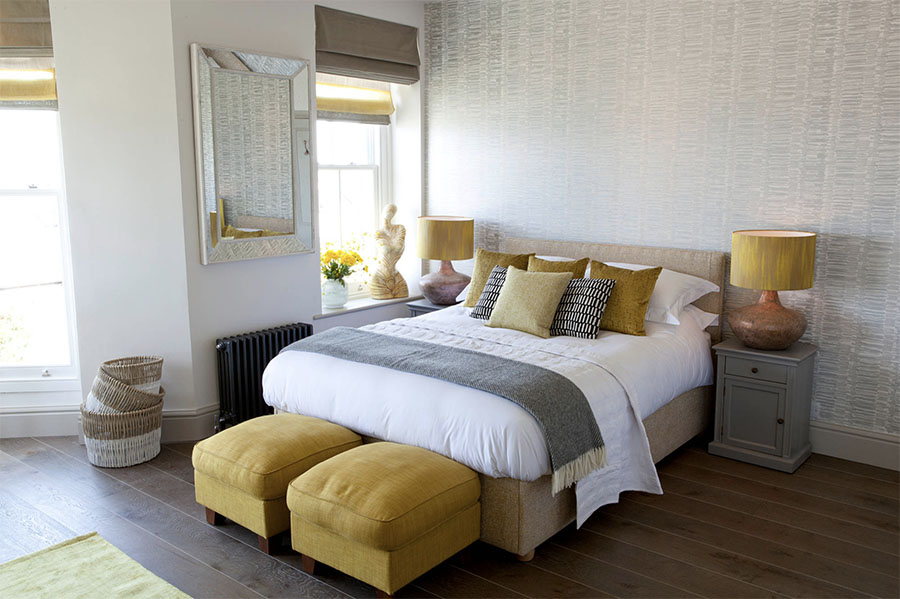 Bedroom with fabric shades in Austin home