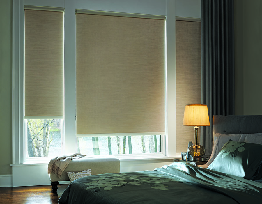 Bedroom with room darkening designer roller shades