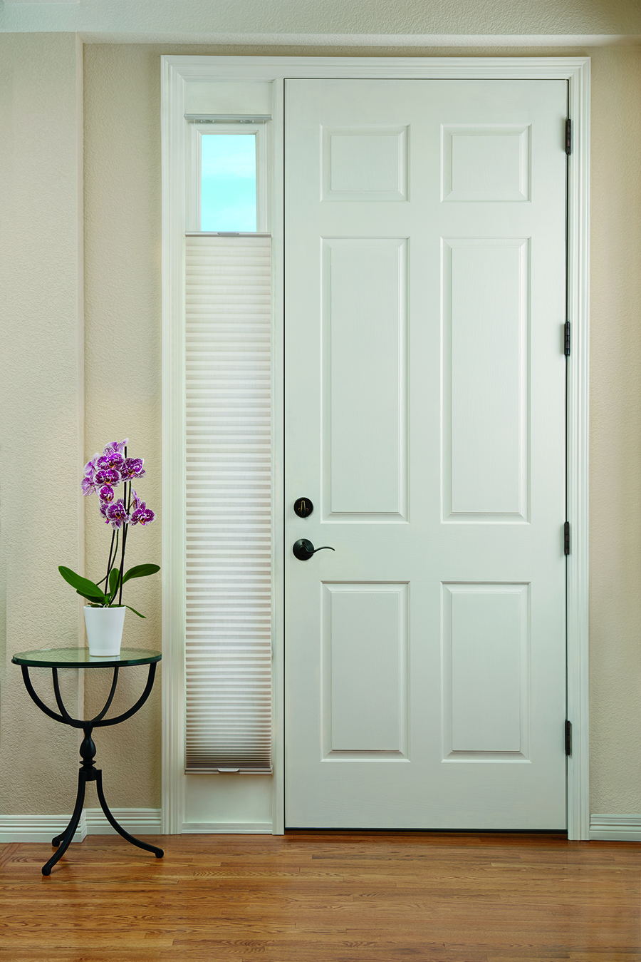 Honeycomb shades on sidelight of front door.