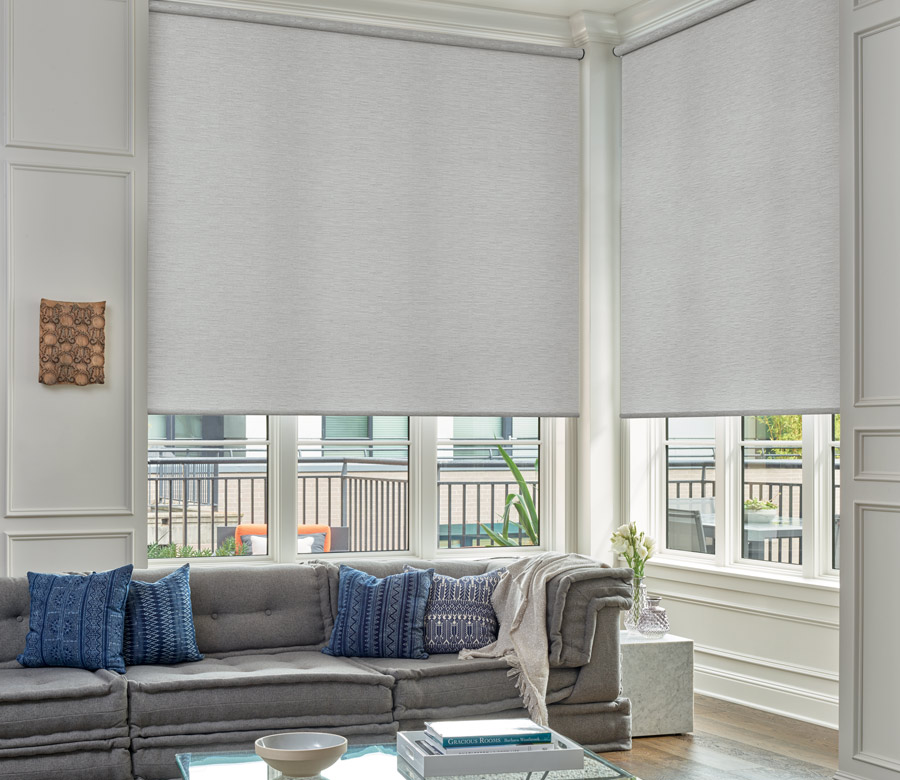 corner of Hudson Bend home with windows covered with designer roller shades in Austin TX