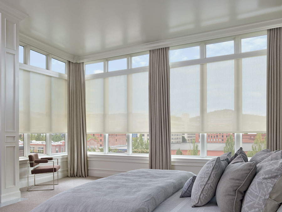 Austin TX home largest windows covered with roller shades and draperies