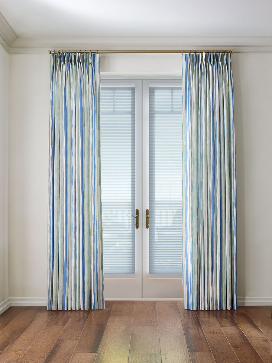 french doors with cellular shades framed with blue striped draperies in Austin TX