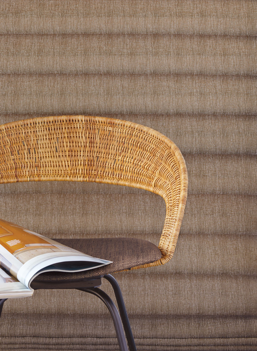 soft brown roman shades next to woven wicker chair