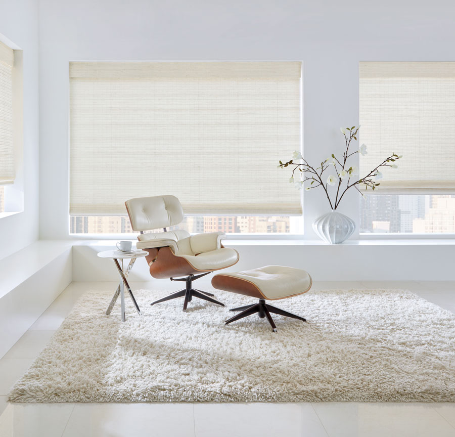 White woven window shades and eames lounge chair in white living room