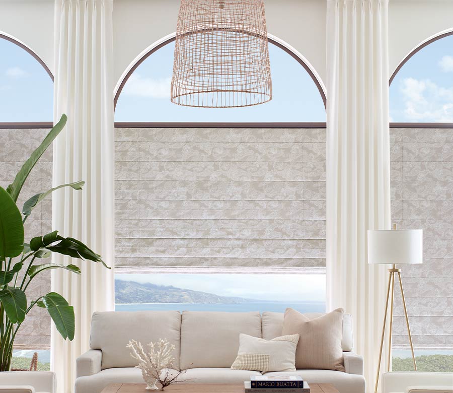 floor to ceiling arched window coverings in modern neutral living room Austin, TX