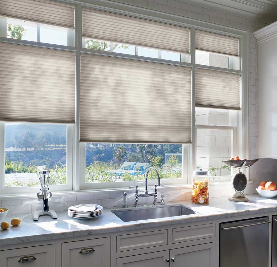 Duette Honeycomb shades over windows and the kitchen sink.