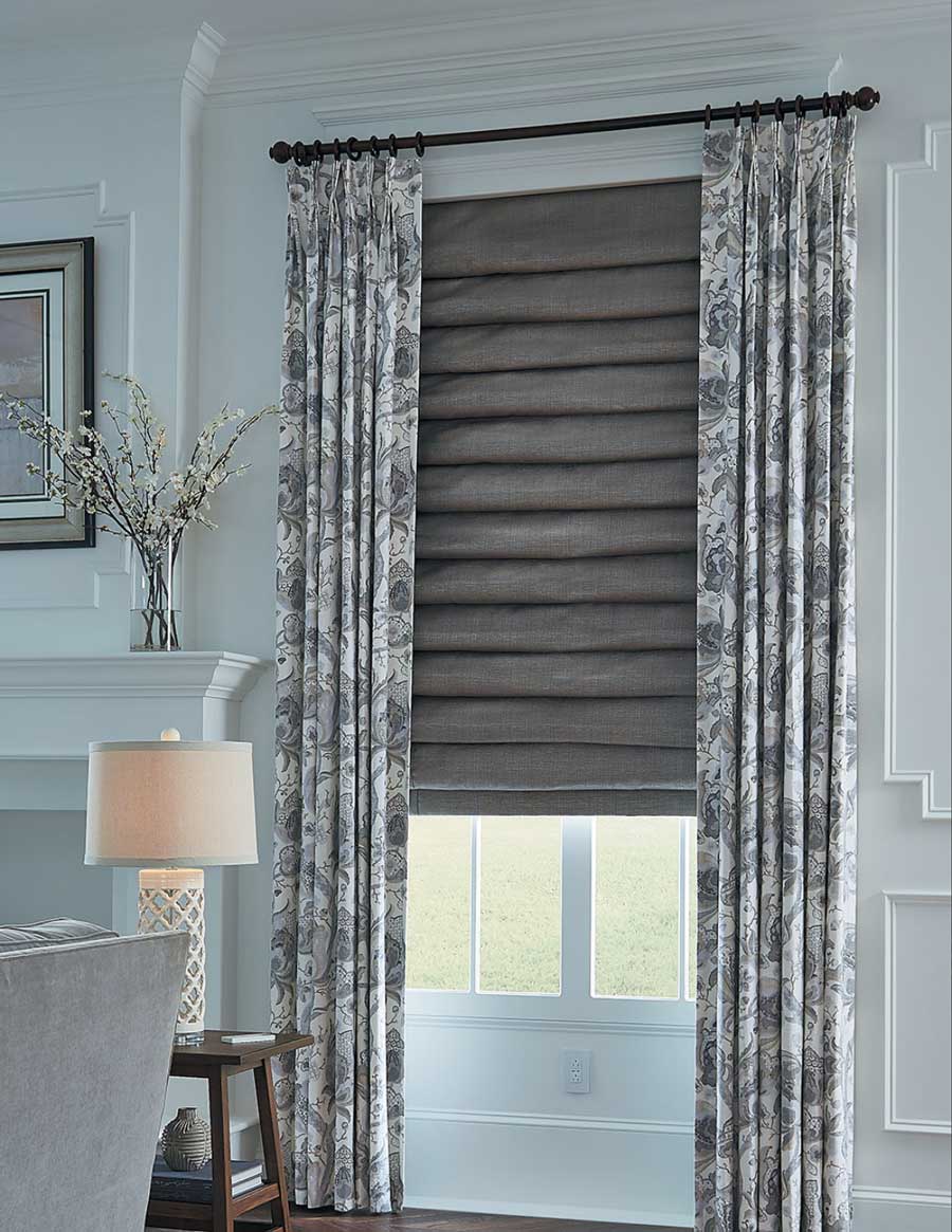 layered fabrics with roman shades and draperies