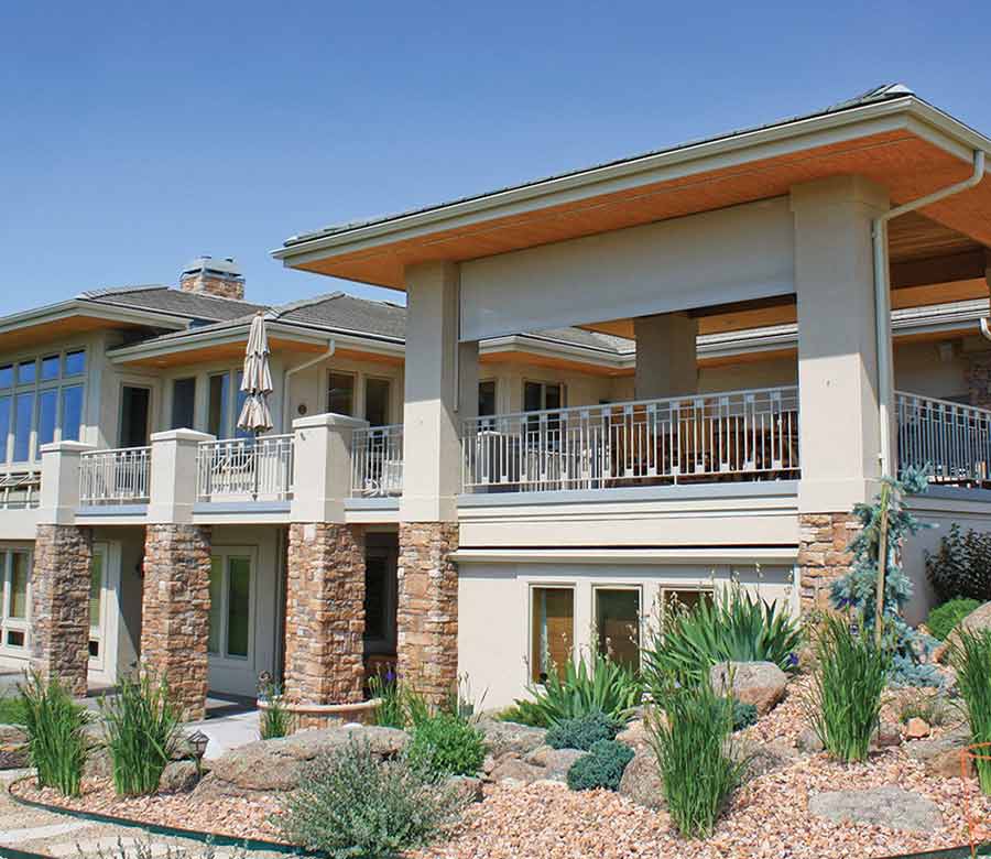 Cream colored exterior roller solar shades in Austin, TX