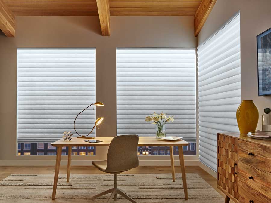 Vignette® Modern Roman Shades in an office with a modern desk and chair