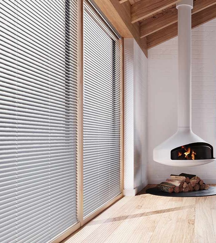 aluminum blinds on floor to ceiling windows in home with vaulted ceiling