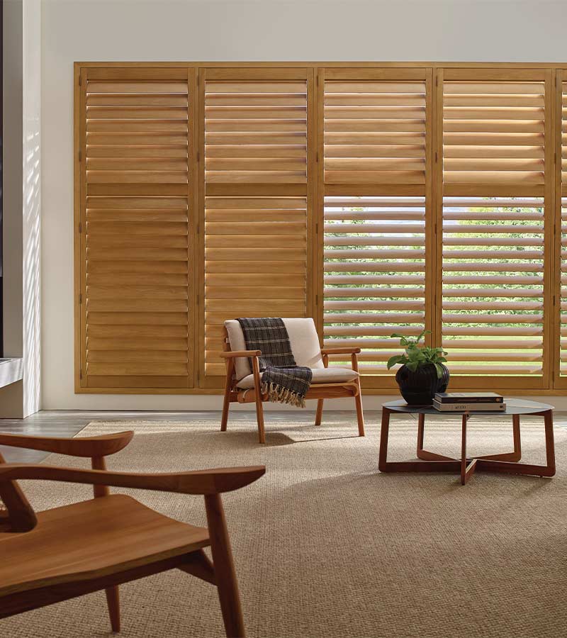 energy-efficient-heritance-hardwood-shutters-window-treatments-austin-window-fashions wood shutters for large window in living room energy efficient