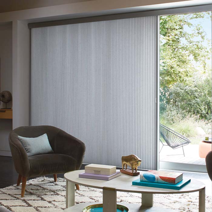 Duette® Vertiglide™ vertical cellular shades on sliding glass doors for energy efficiency and light control
