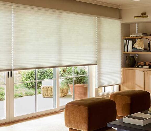 Duette Honeycomb Shades covering living room windows and sliding glass doors