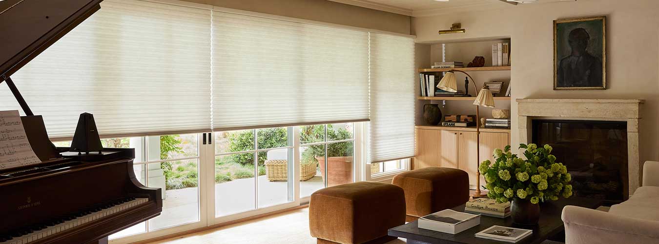 Duette Honeycomb Shades covering living room windows and sliding glass doors