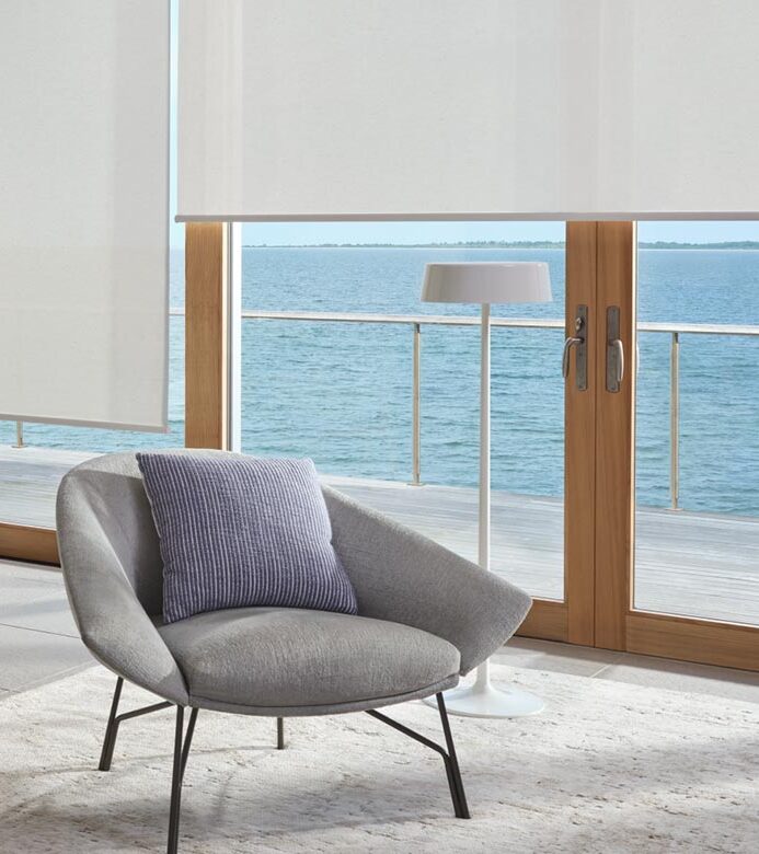white designer shades with blue chair near balcony on glass doors