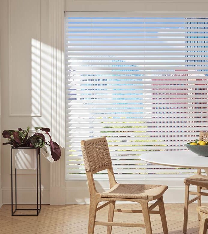 aria-fabric-blinds-open-hunter-douglas-austin-window-fashions Aria fabric blinds filtering natural light through a window