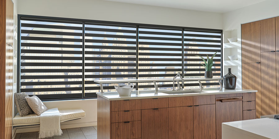 Designer Banded Shades on large kitchen windows overlooking the landscape