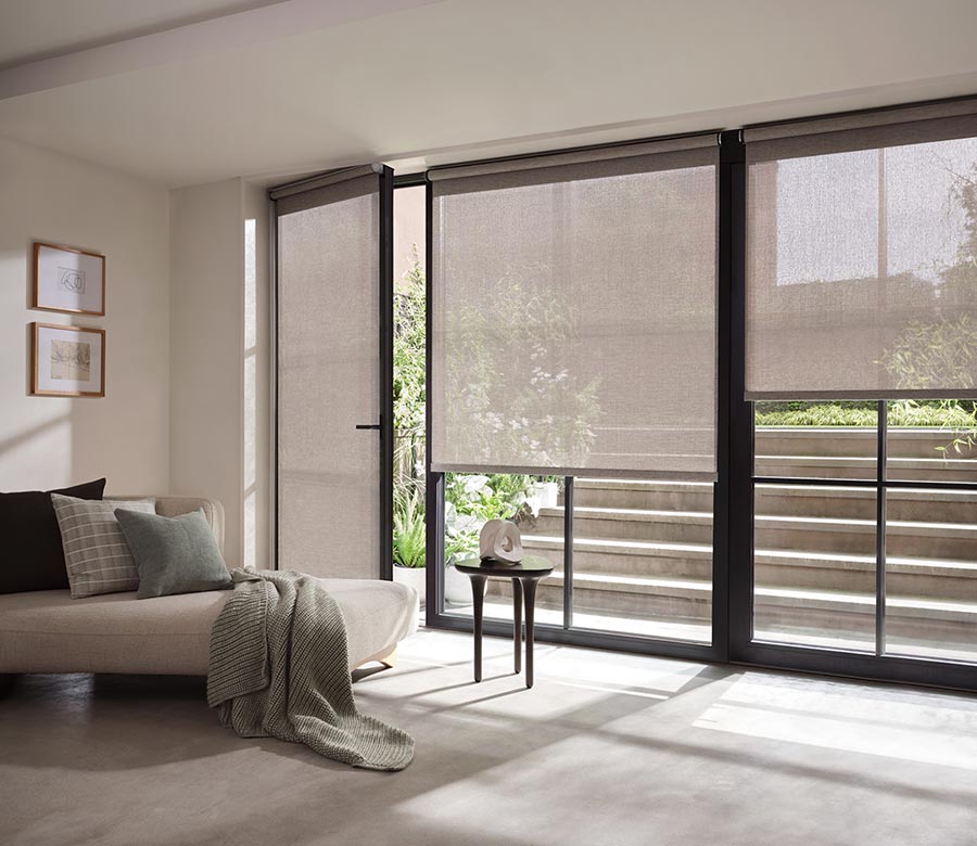 sheer-grey-designer-screen-shades-with-handle-austin-window-fashions living room with large window screen shades for light filtering